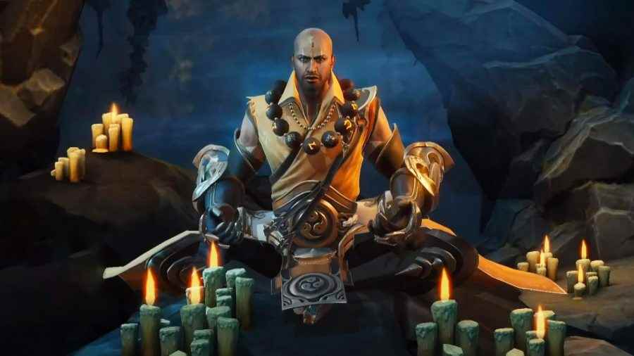 Diablo Immortal kademe listesi: Çok sayıda yanan mumun önünde bağdaş kurmuş oturan Keşiş