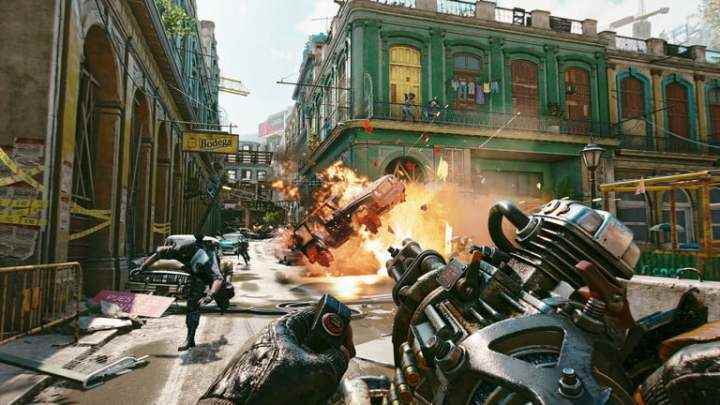 Far Cry 6'da bir karakter gatling silahı ateşler.
