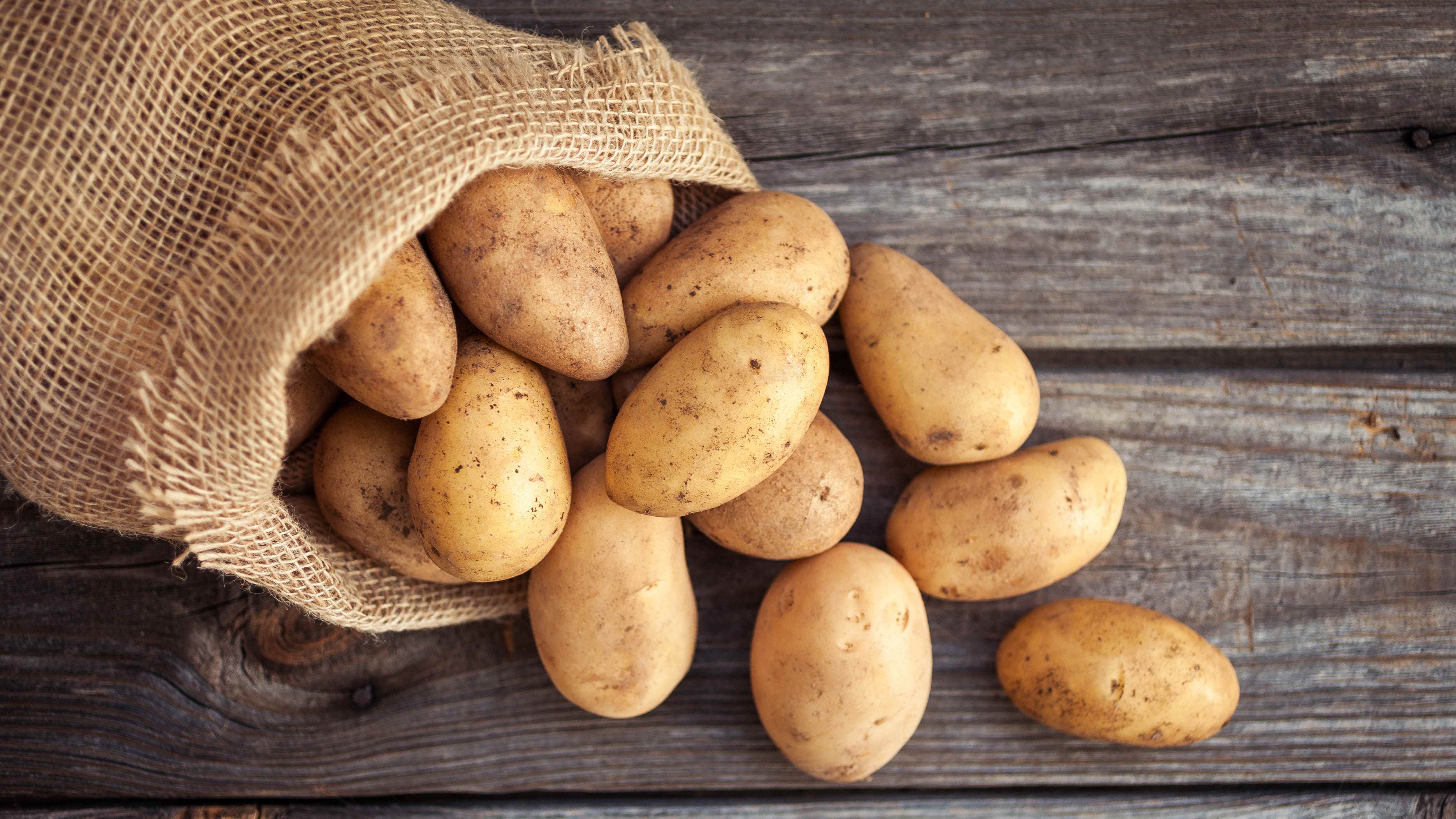 Ahşap bir yüzey üzerinde bir torba patates