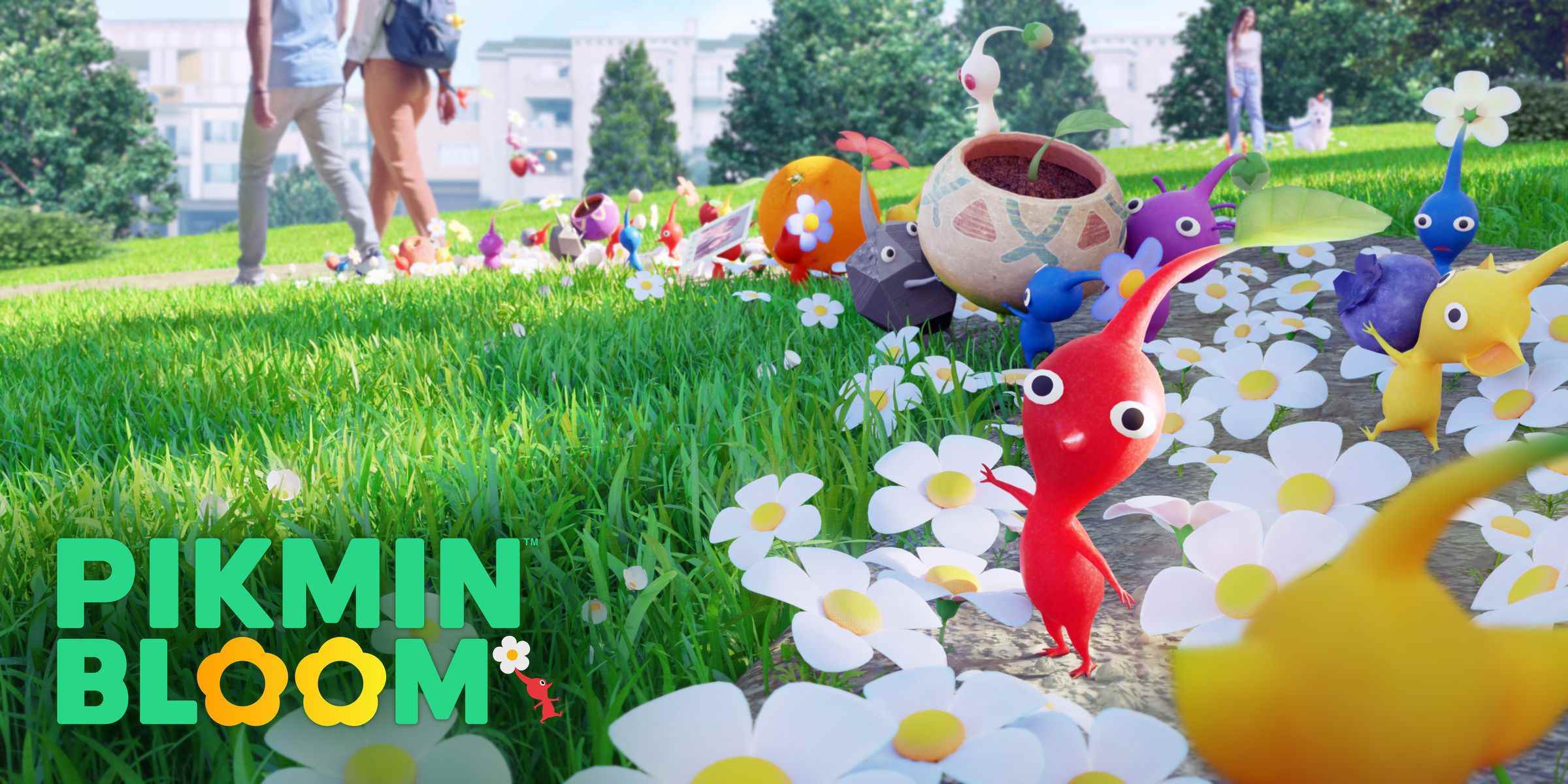 Pikmin Bloom'un ekran görüntüsü: Papatyalarla dolu bir çimin ortasında büyük kafaları olan renkli küçük yaratıklar.