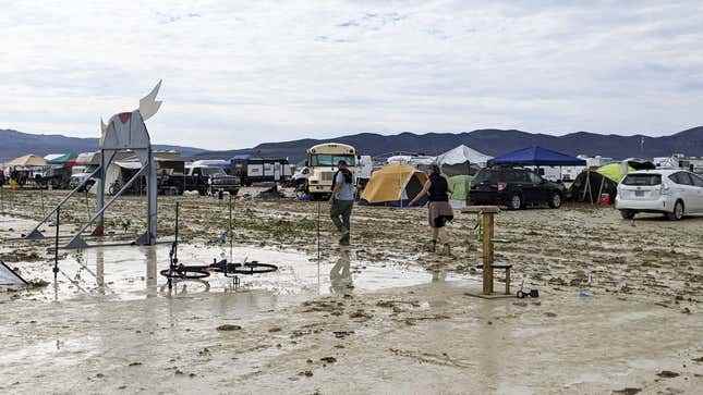 2 Eylül 2023'te Amerika Birleşik Devletleri'nin Nevada kentinde düzenlenen Burning Man etkinliği sırasında insanlar sağanak yağmurun ardından çamurda yürüyor.